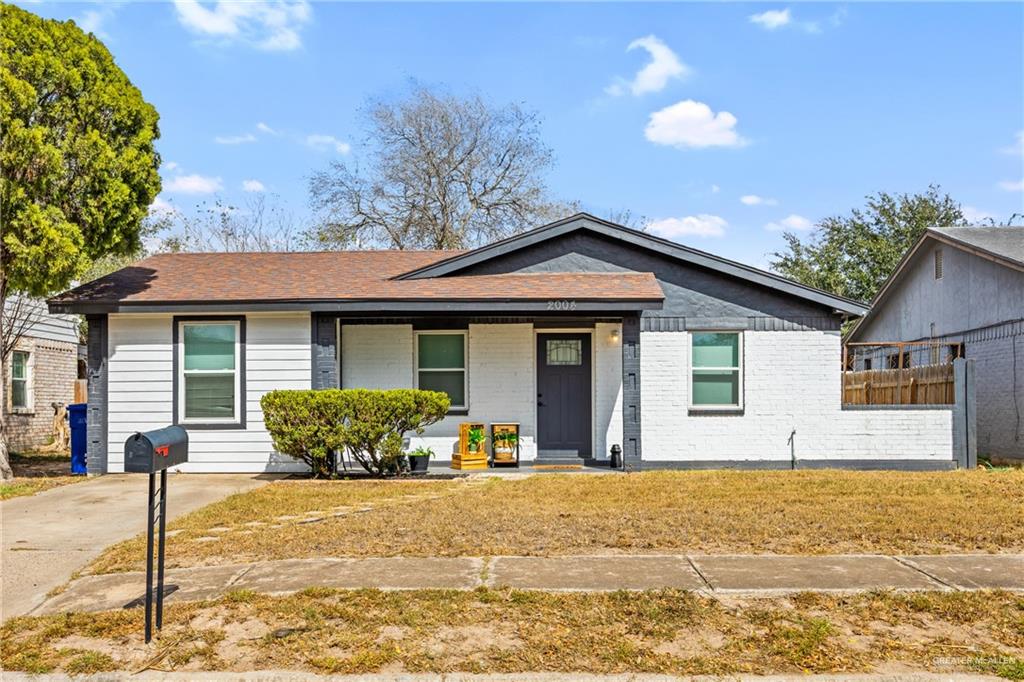 a front view of a house with a yard and seating space