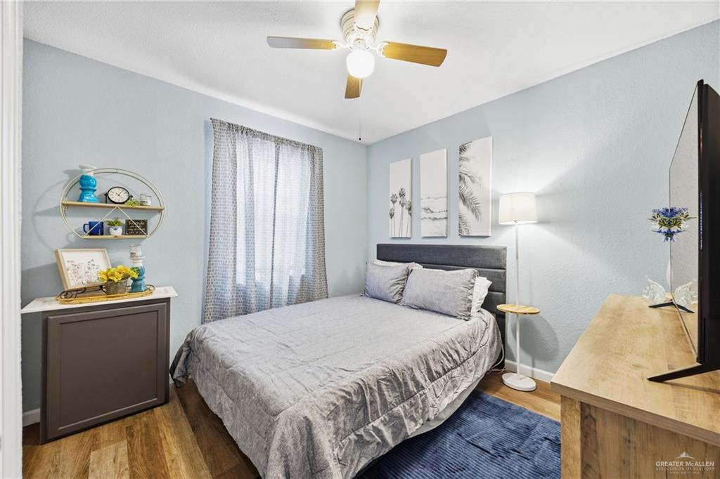 2004 Hawk Avenue McAllen, TX 78504 - Photo 13 of 15 a bedroom with a bed and a chandelier