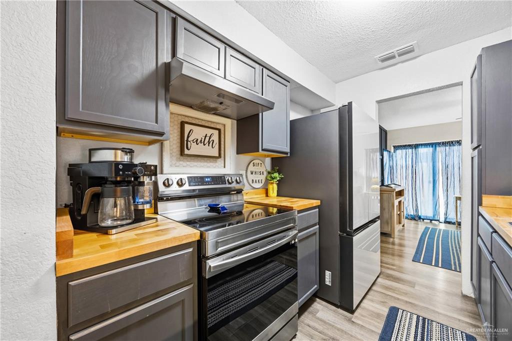 2004 Hawk Avenue McAllen, TX 78504 - Photo 6 of 15 a kitchen with stainless steel appliances a stove and a refrigerator