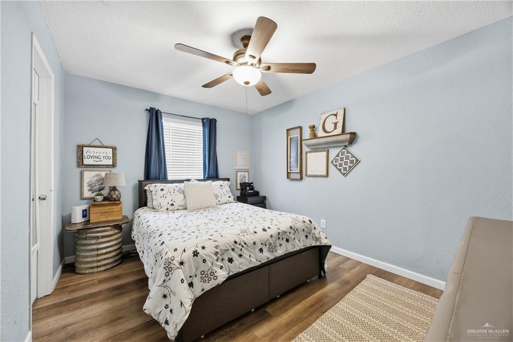 2004 Hawk Avenue McAllen, TX 78504 - Photo 9 of 15 a bedroom with a large bed and a chandelier