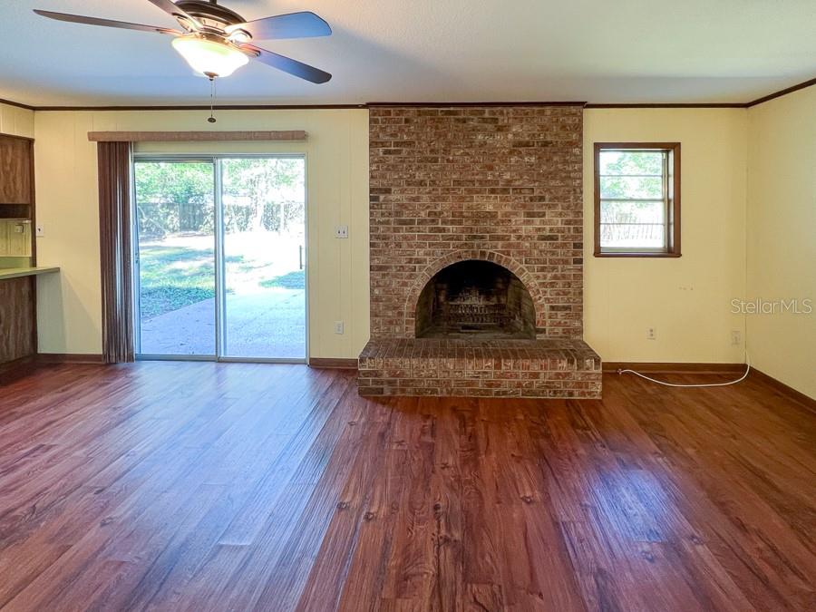2915 Northwest 31 Terrace Gainesville, FL 32605 - Photo 14 of 33 a living room with a fireplace and wooden floor