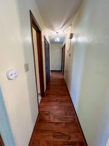 a view of a hallway with wooden floor