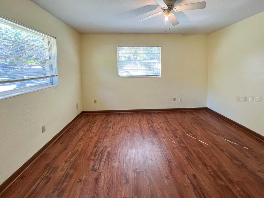 2915 Northwest 31 Terrace Gainesville, FL 32605 - Photo 19 of 33 an empty room with wooden floor and windows