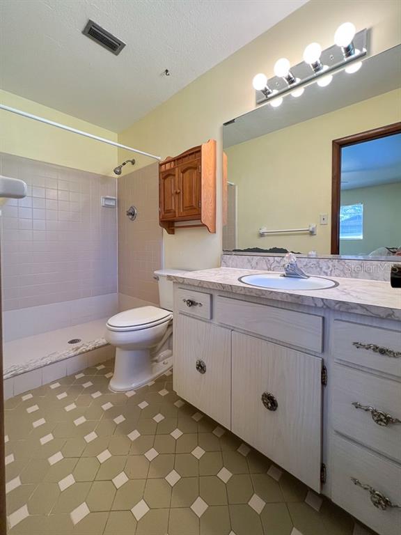 2915 Northwest 31 Terrace Gainesville, FL 32605 - Photo 21 of 33 a bathroom with a sink a toilet and mirror