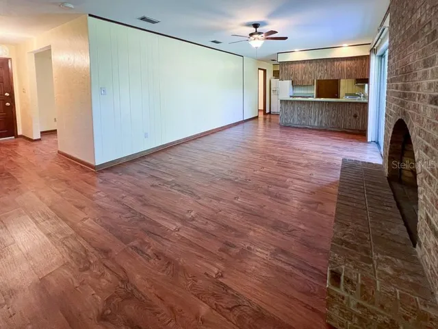 a view of a kitchen with a sink and a large mirror
