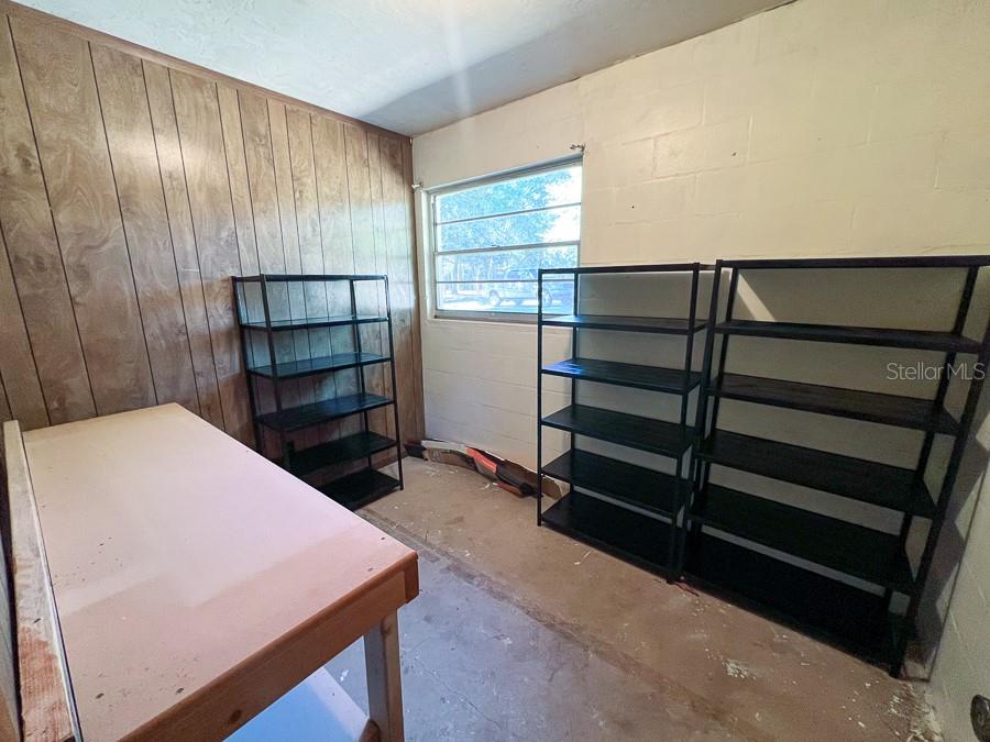 2915 Northwest 31 Terrace Gainesville, FL 32605 - Photo 27 of 33 a hallway with a wooden floor and furniture