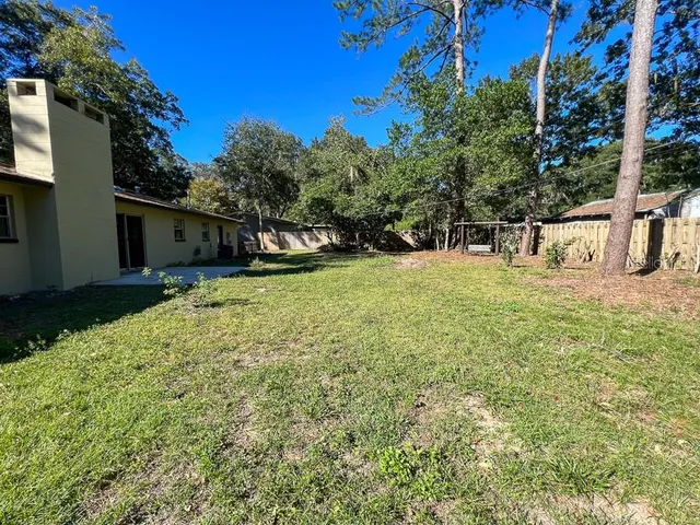 a backyard of a house with table and chairs