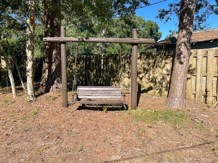 2915 Northwest 31 Terrace Gainesville, FL 32605 - Photo 32 of 33 a backyard of a house with wooden floor and fence
