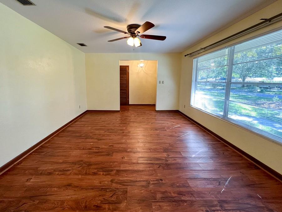 2915 Northwest 31 Terrace Gainesville, FL 32605 - Photo 4 of 33 wooden floor in an empty room with a window