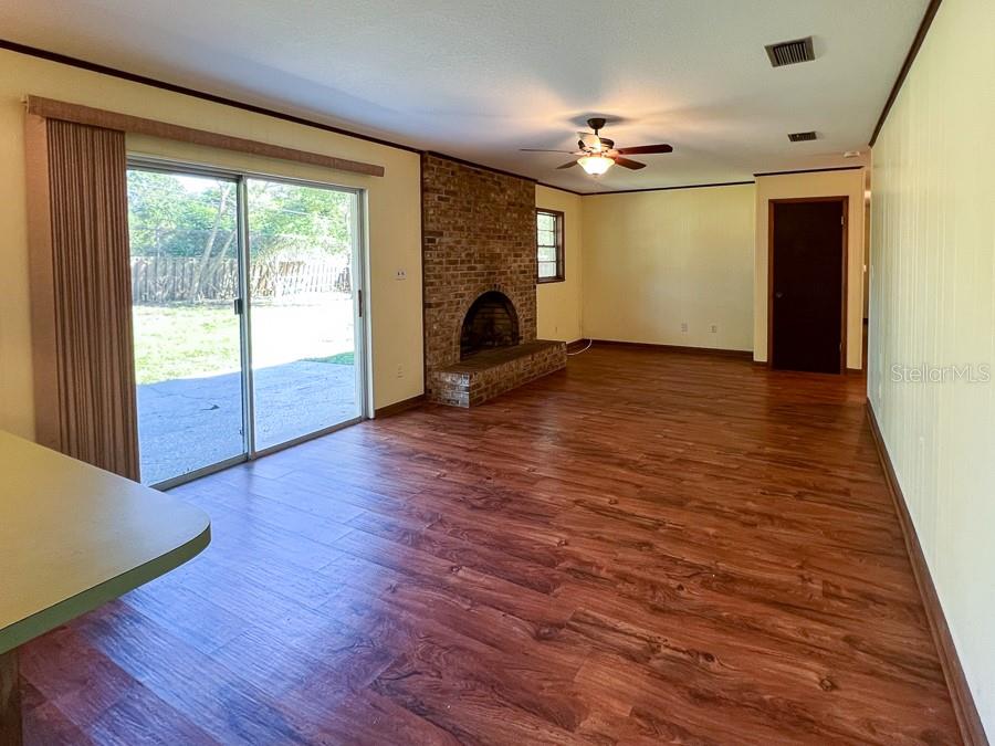 2915 Northwest 31 Terrace Gainesville, FL 32605 - Photo 8 of 33 an empty room with wooden floor fireplace and windows