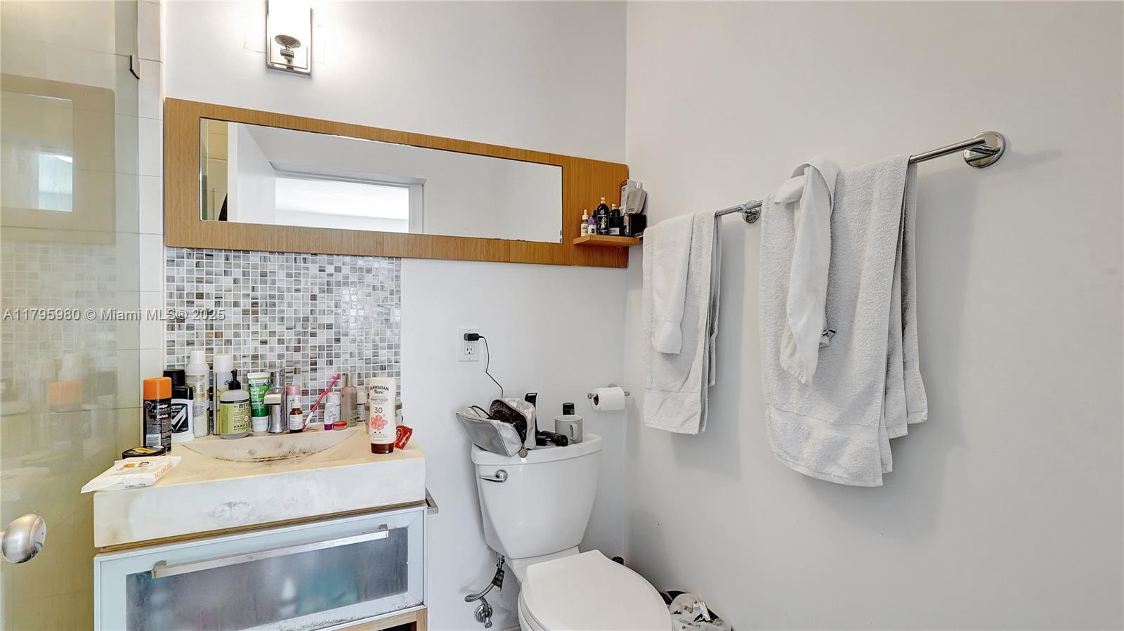 Flamingo-Lummus Miami Beach, FL 33139 - Photo 30 of 63 a bathroom with a sink vanity mirror and toilet