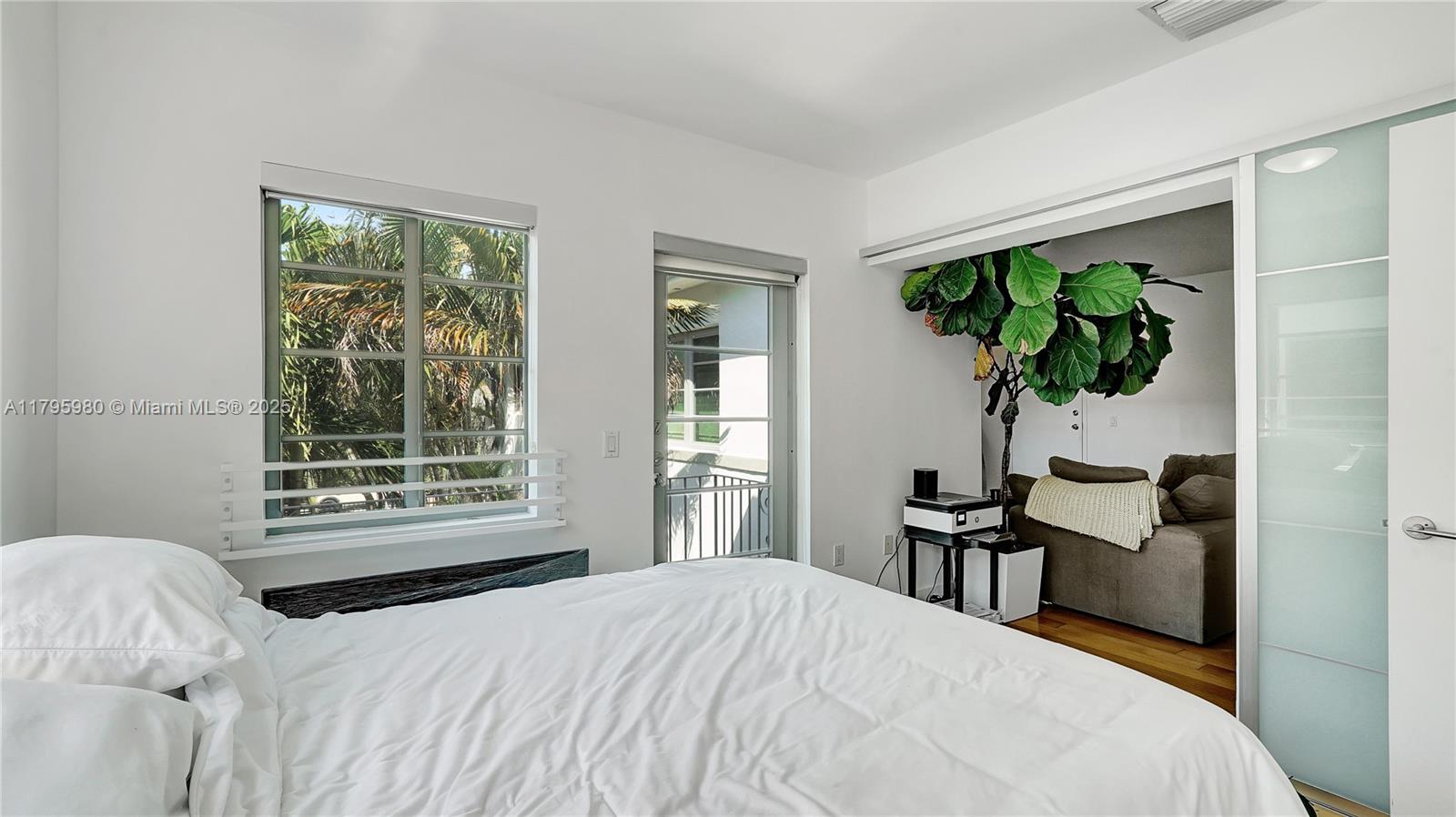 Flamingo-Lummus Miami Beach, FL 33139 - Photo 33 of 63 a bedroom with a bed table and a window