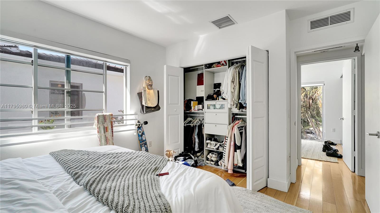 Flamingo-Lummus Miami Beach, FL 33139 - Photo 44 of 63 a bedroom with a bed a large window and walk in closet