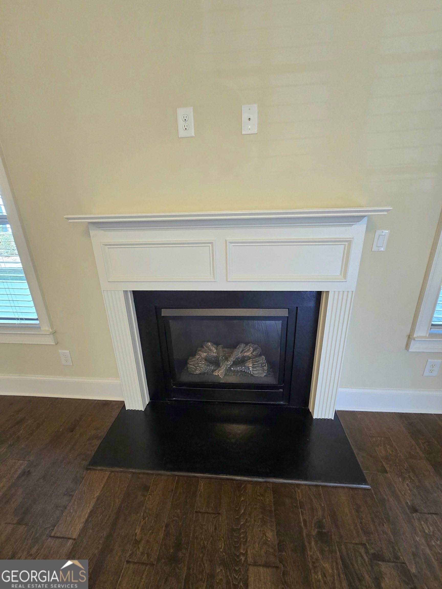 9 Ravine Drive Newnan, GA 30265 - Photo 11 of 46 a living room with a fireplace and a wooden floor