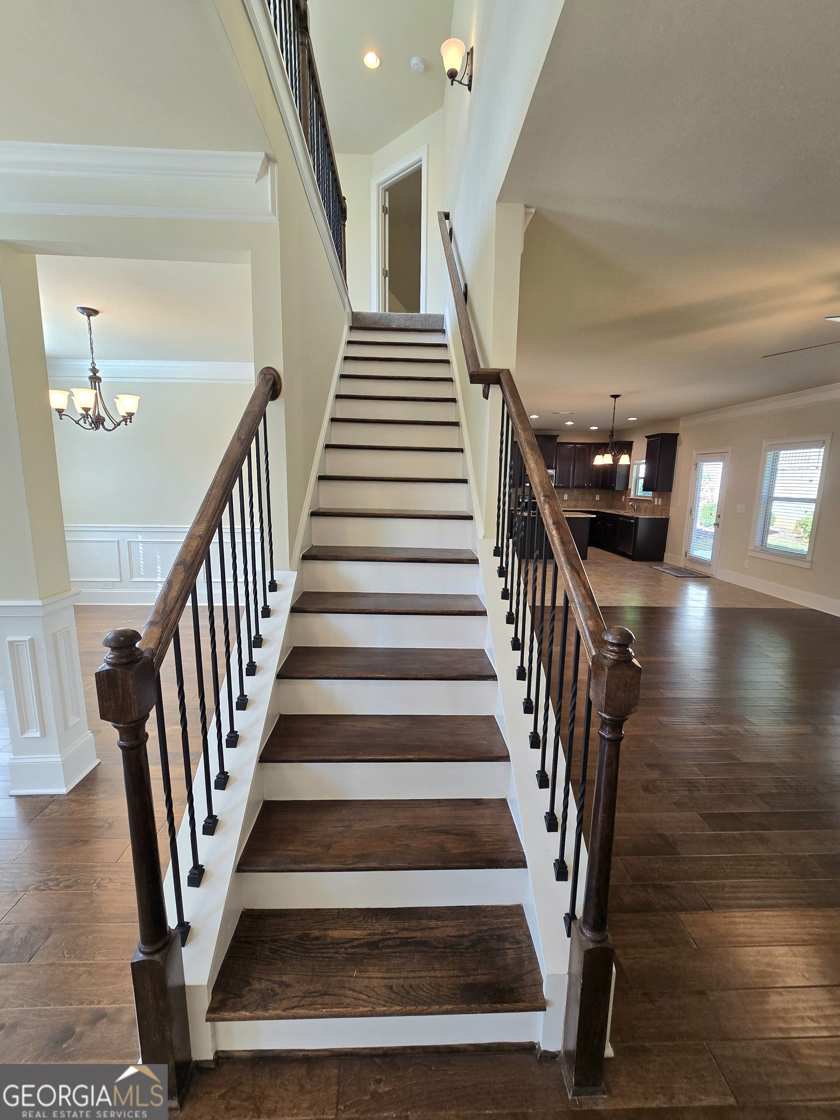 9 Ravine Drive Newnan, GA 30265 - Photo 18 of 46 a view of staircase with lots of frames on wall and wooden floor