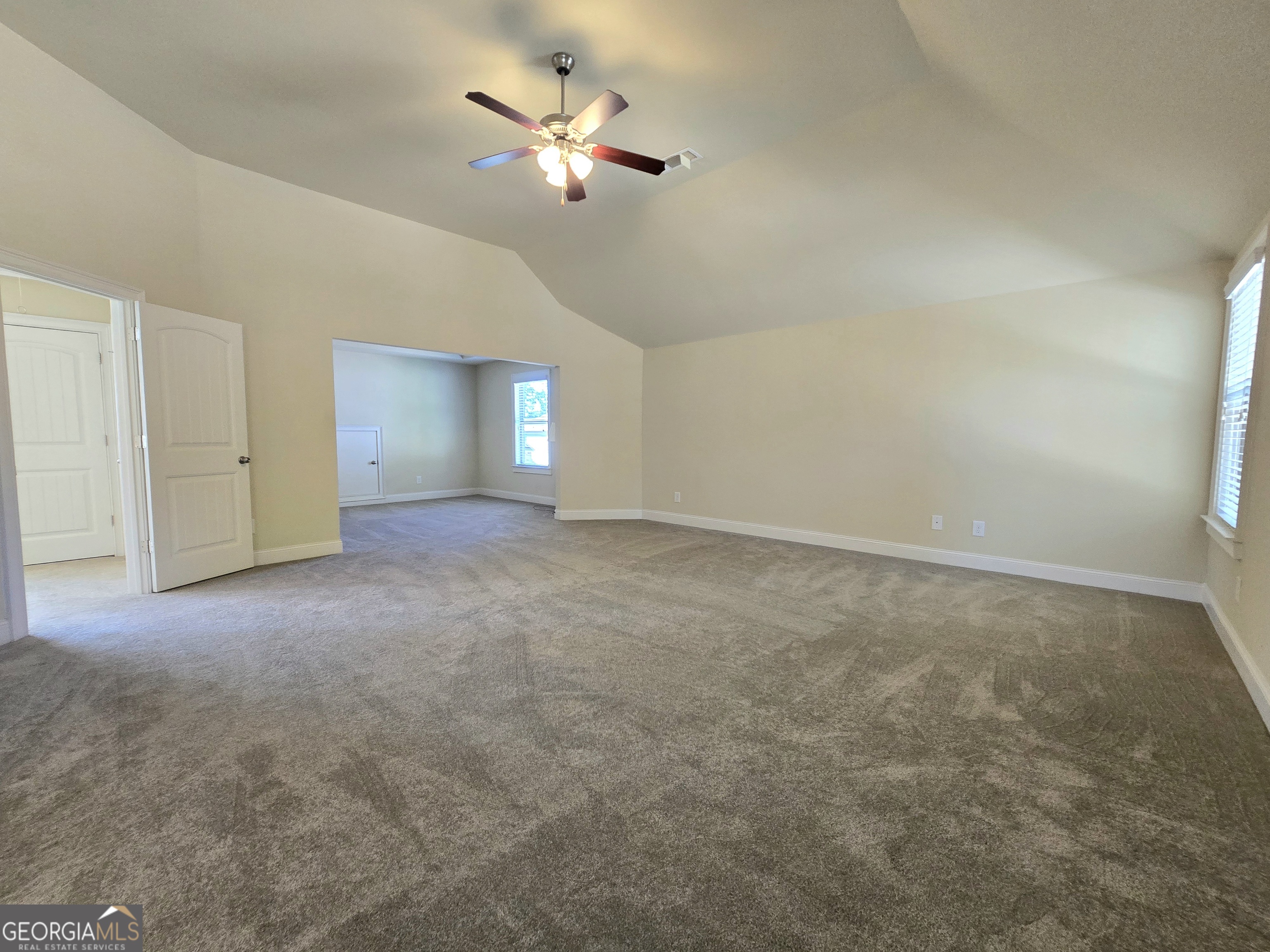 9 Ravine Drive Newnan, GA 30265 - Photo 23 of 46 an empty room with chandelier fan and windows