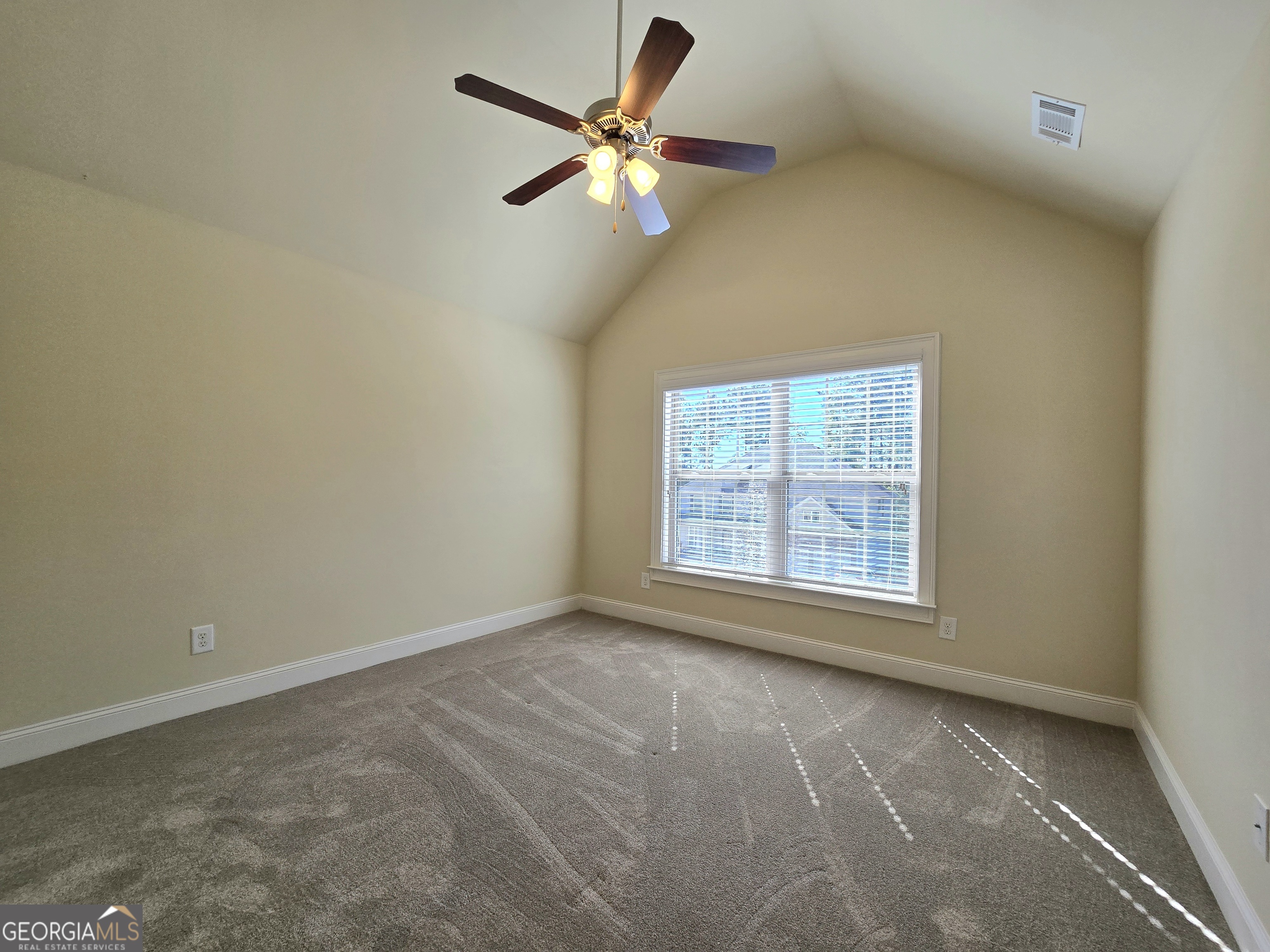 9 Ravine Drive Newnan, GA 30265 - Photo 32 of 46 an empty room with a window and a fan