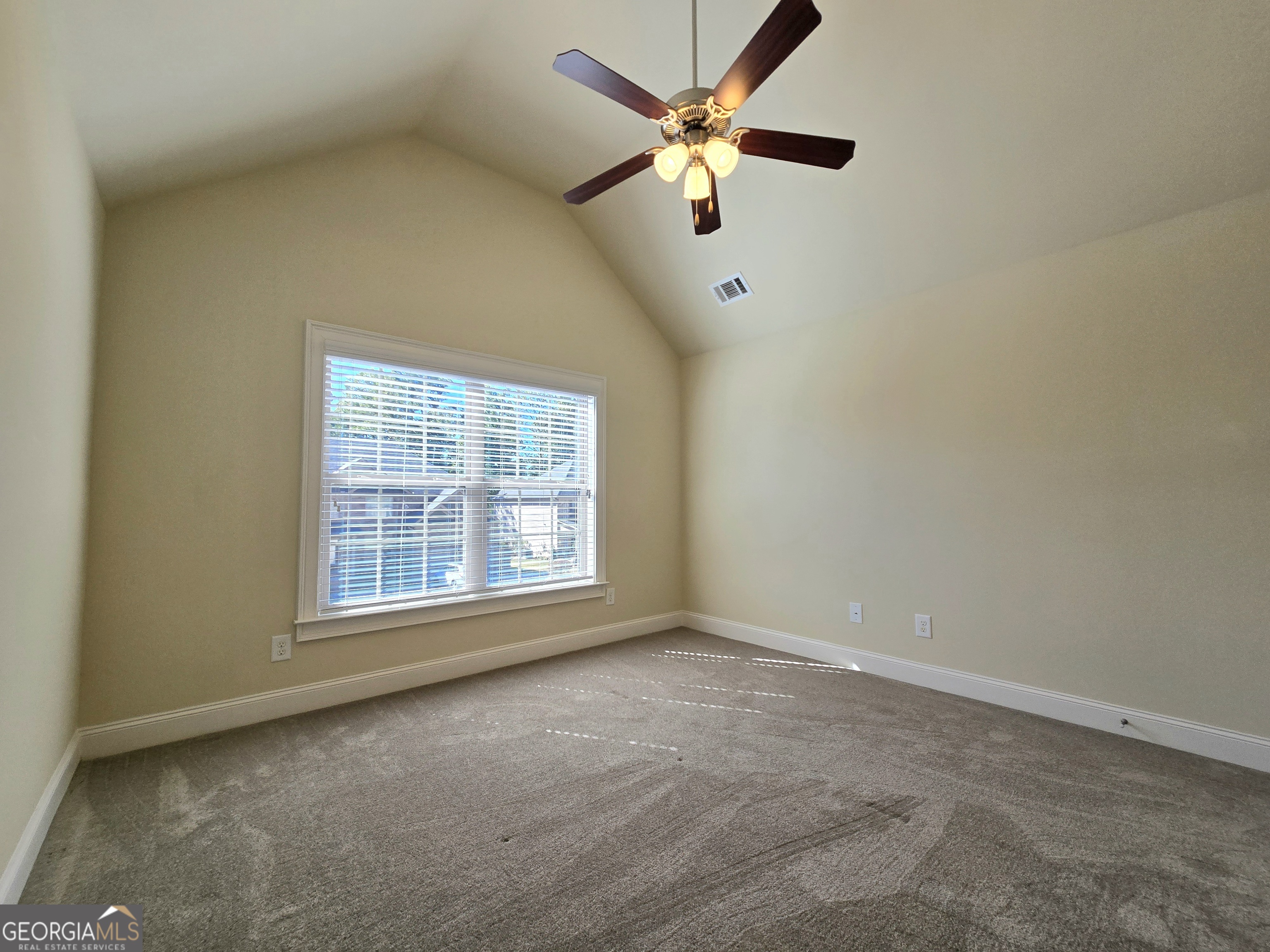 9 Ravine Drive Newnan, GA 30265 - Photo 33 of 46 an empty room with chandelier fan and windows