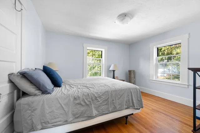a view of a bedroom with furniture and wooden floor