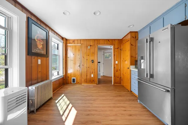 a large room with a large window and wooden floor