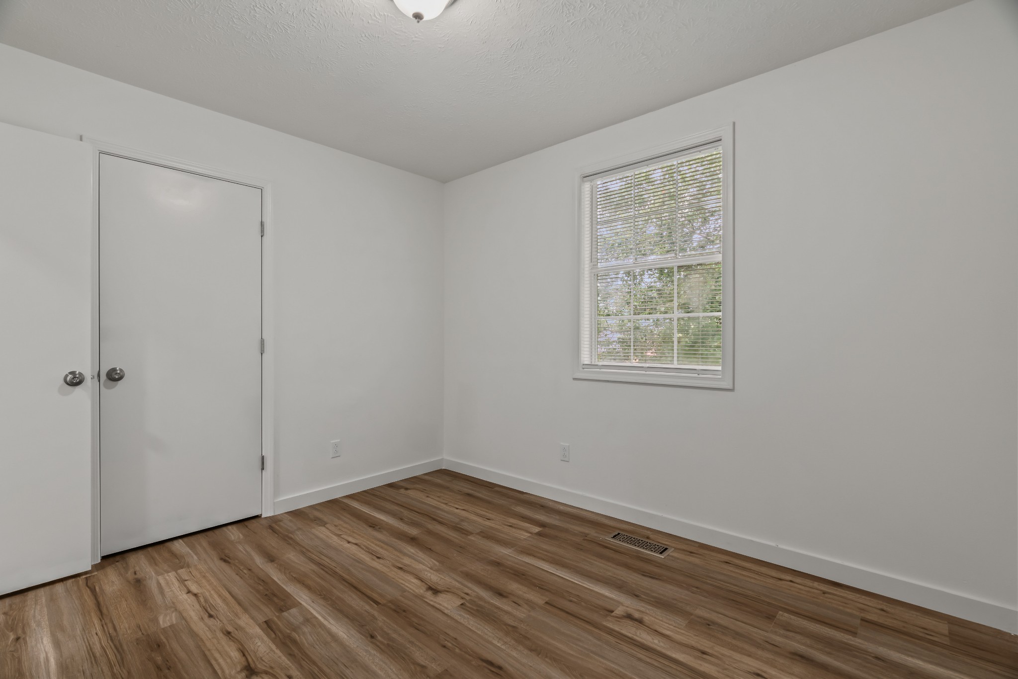 183 Cedar Street Carthage, TN 37030 - Photo 15 of 18 a view of an empty room with wooden floor and a window