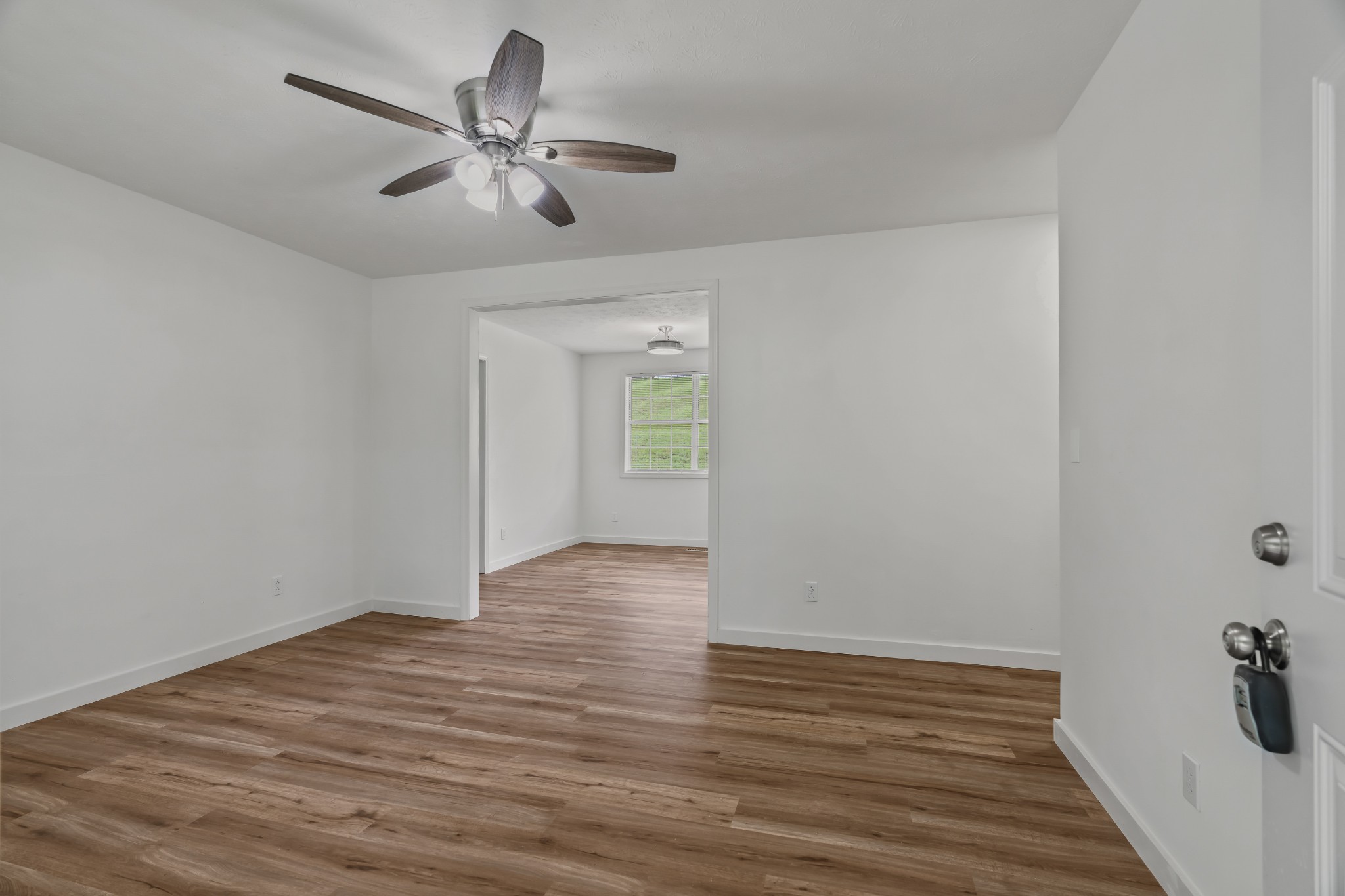 183 Cedar Street Carthage, TN 37030 - Photo 3 of 18 a view of a livingroom with wooden floor and a ceiling fan