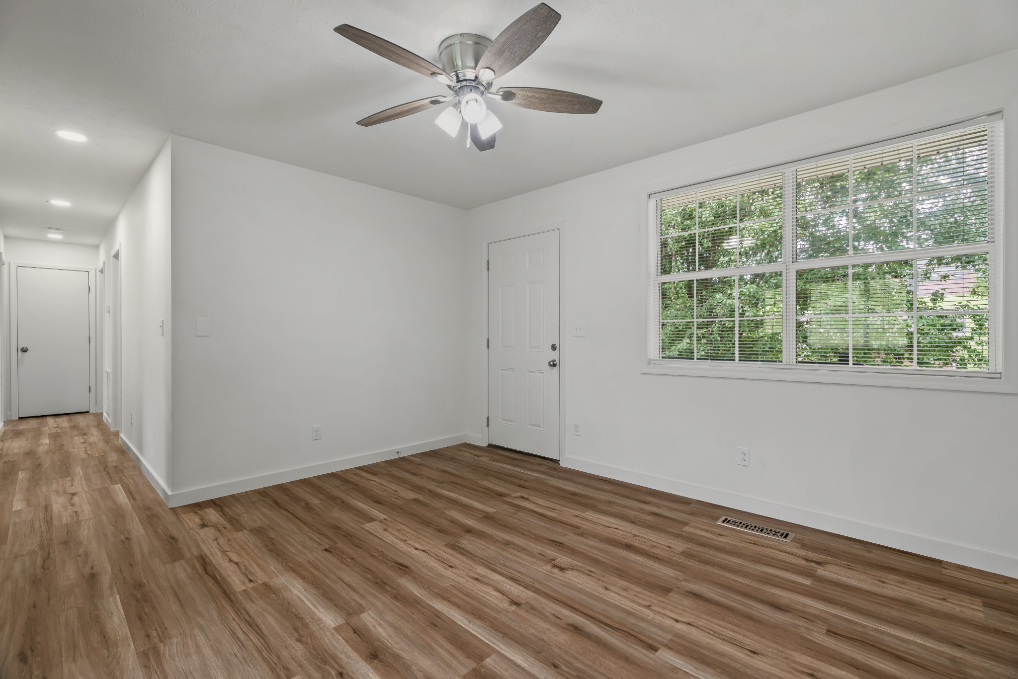 183 Cedar Street Carthage, TN 37030 - Photo 4 of 18 a view of empty room with wooden floor and fan