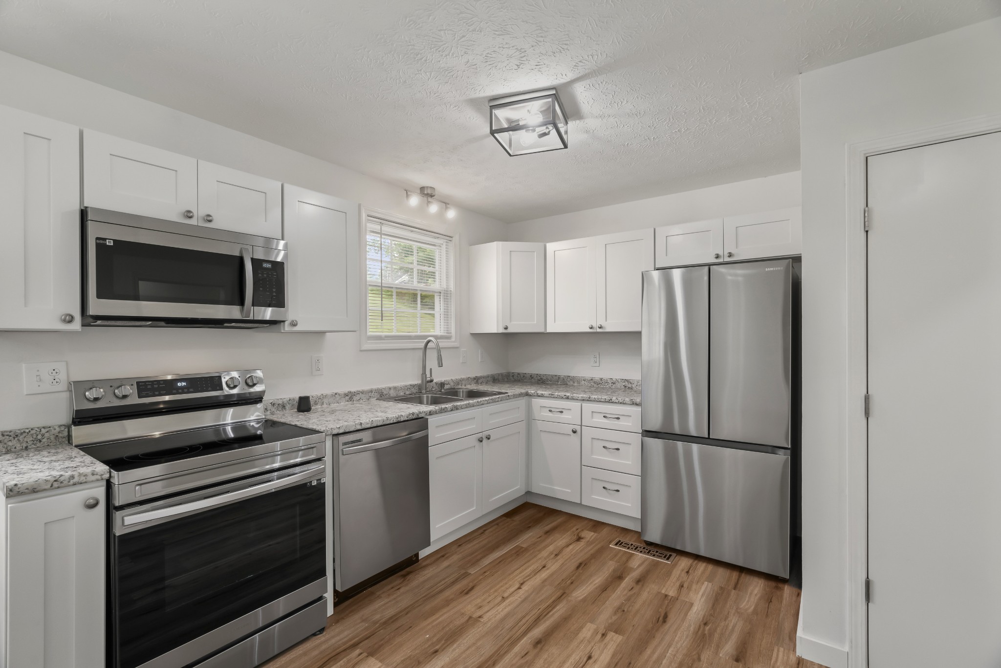 183 Cedar Street Carthage, TN 37030 - Photo 8 of 18 a kitchen with stainless steel appliances a stove microwave and refrigerator