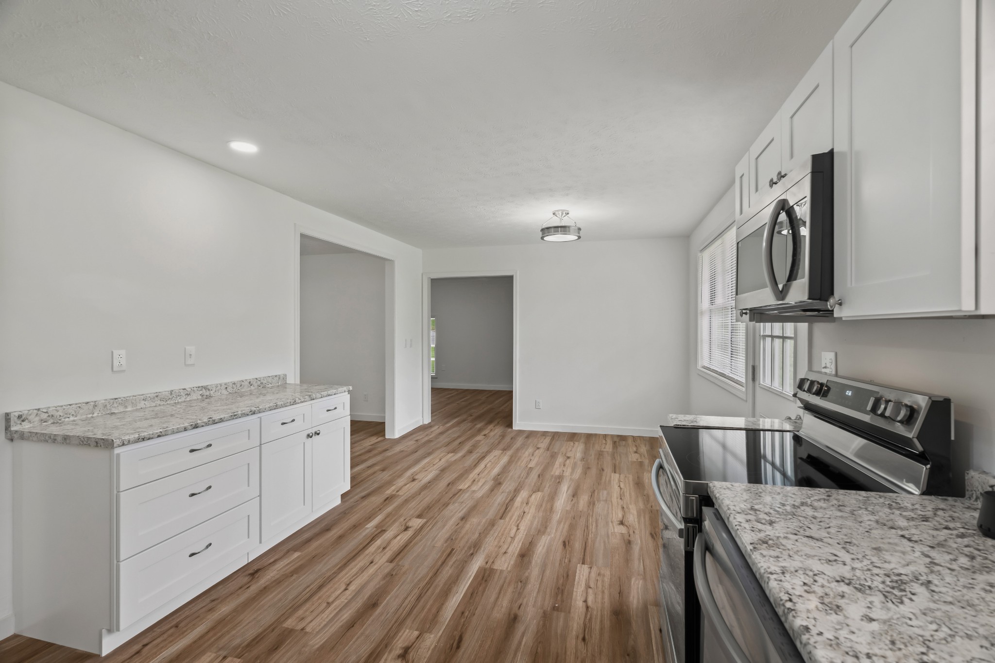 183 Cedar Street Carthage, TN 37030 - Photo 9 of 18 a kitchen with granite countertop a stove and cabinets