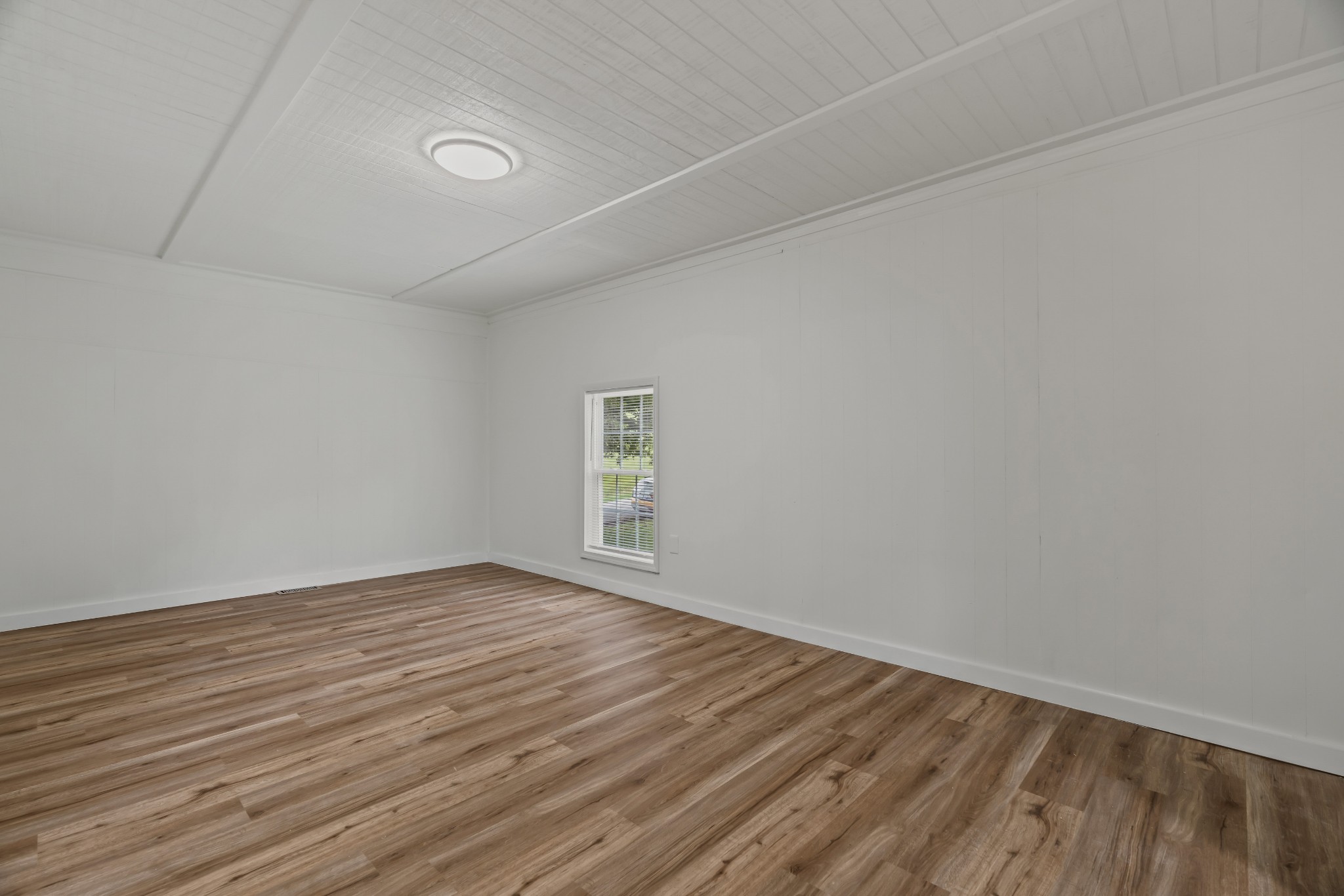 183 Cedar Street Carthage, TN 37030 - Photo 10 of 18 a view of an empty room with wooden floor and a window