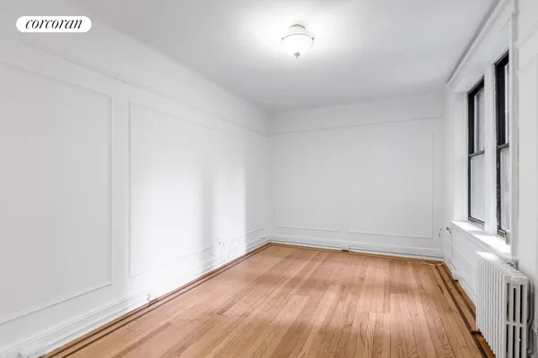a view of room with window and wooden floor