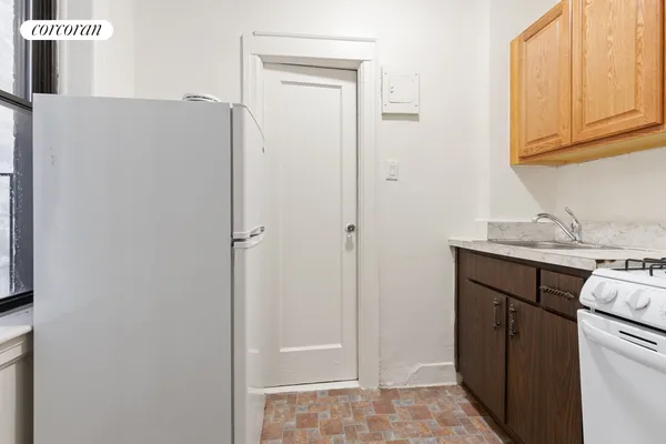 a utility room with cabinets washer and dryer