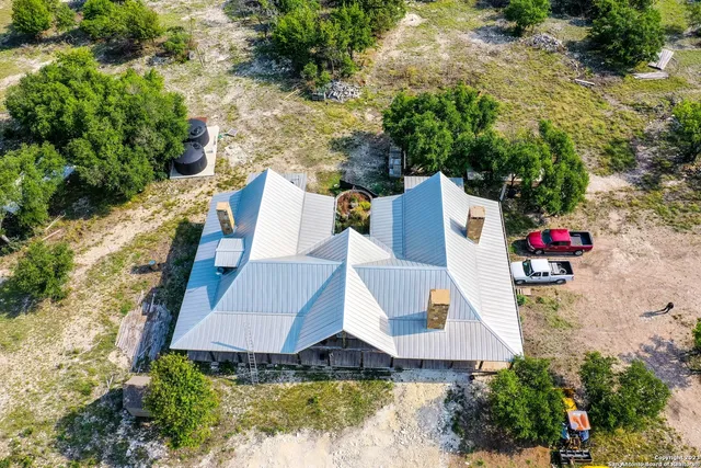 an aerial view of house with yard swimming pool and outdoor seating