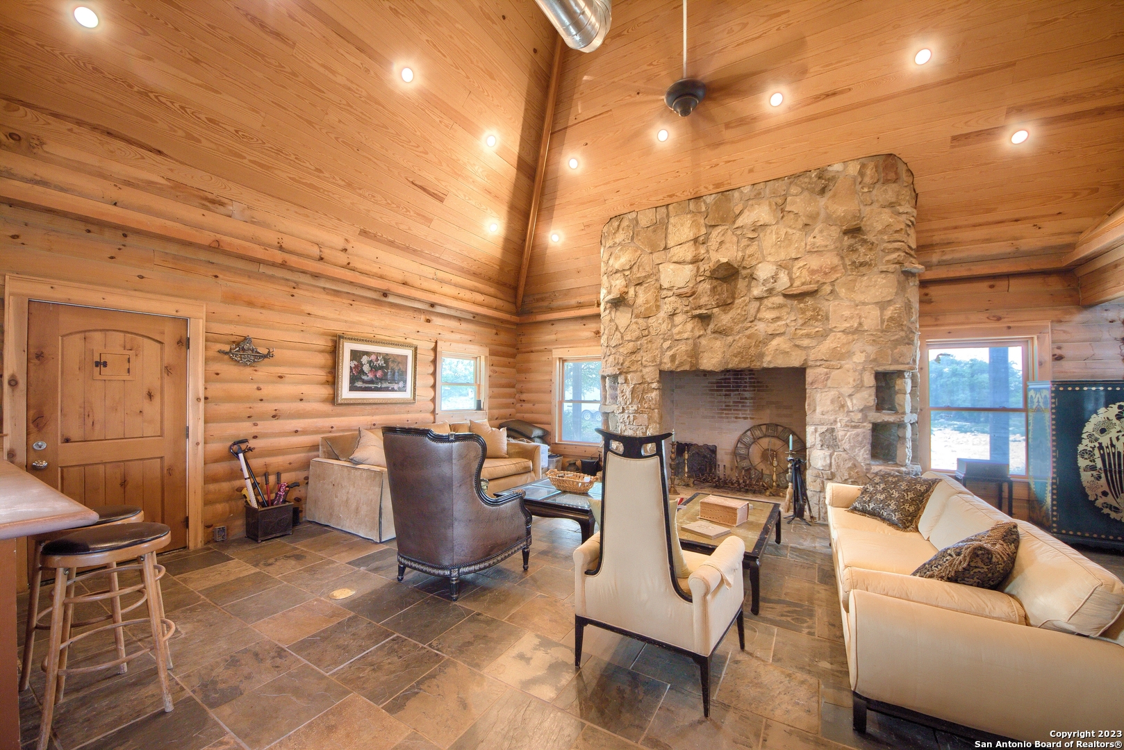 514 Centerfork Road Doss, TX 78618 - Photo 13 of 51 a living room with furniture a fireplace and a dining table with wooden floor