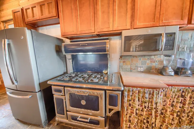 a kitchen with a stove and a refrigerator
