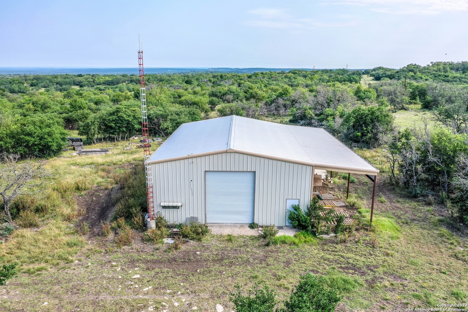 514 Centerfork Road Doss, TX 78618 - Photo 19 of 51 a backyard of a house with lots of green space and garden