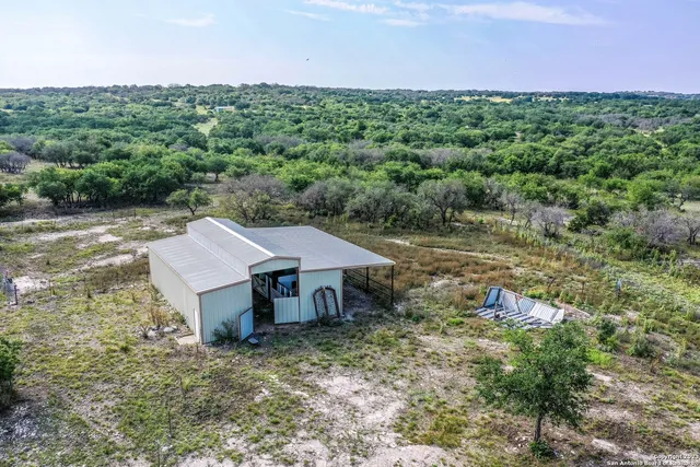 an aerial view of a house with a yard and lake view