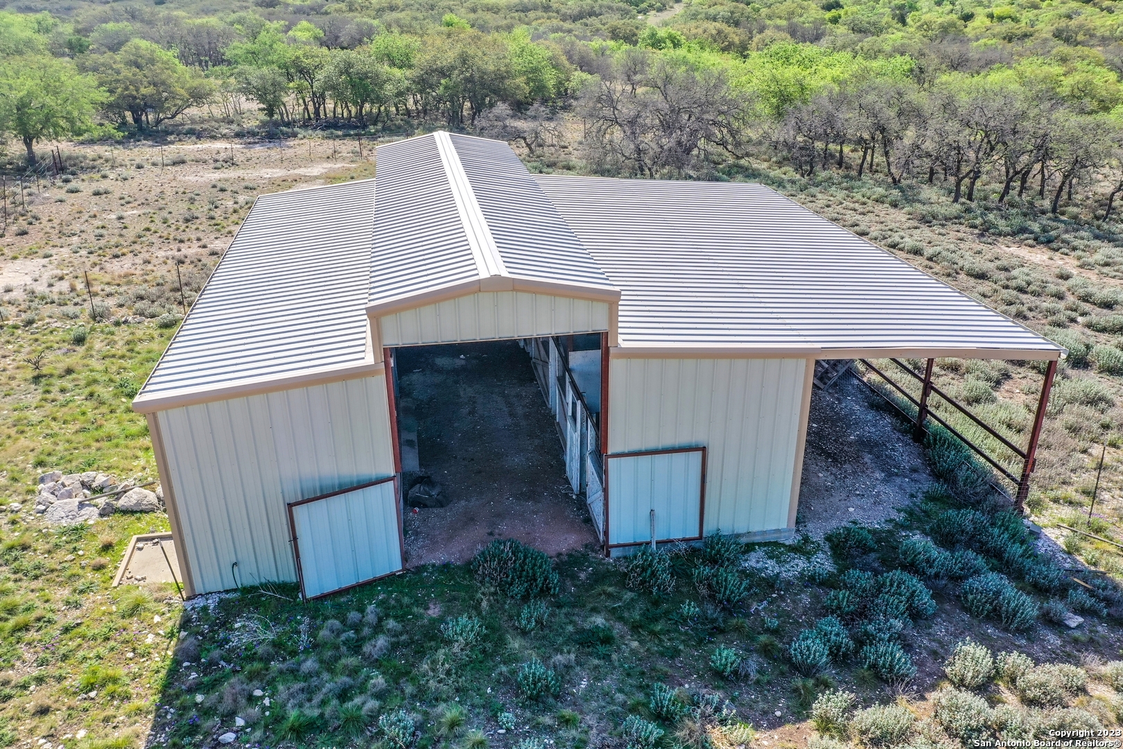 514 Centerfork Road Doss, TX 78618 - Photo 30 of 51 a view of a backyard with barn plants and large tree