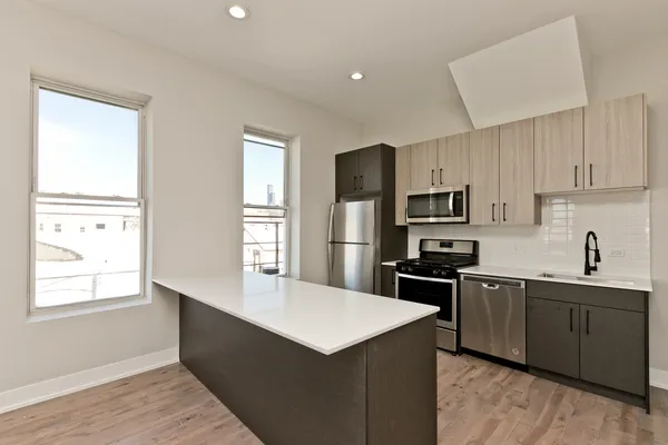 a kitchen with kitchen island a sink dishwasher stove and refrigerator