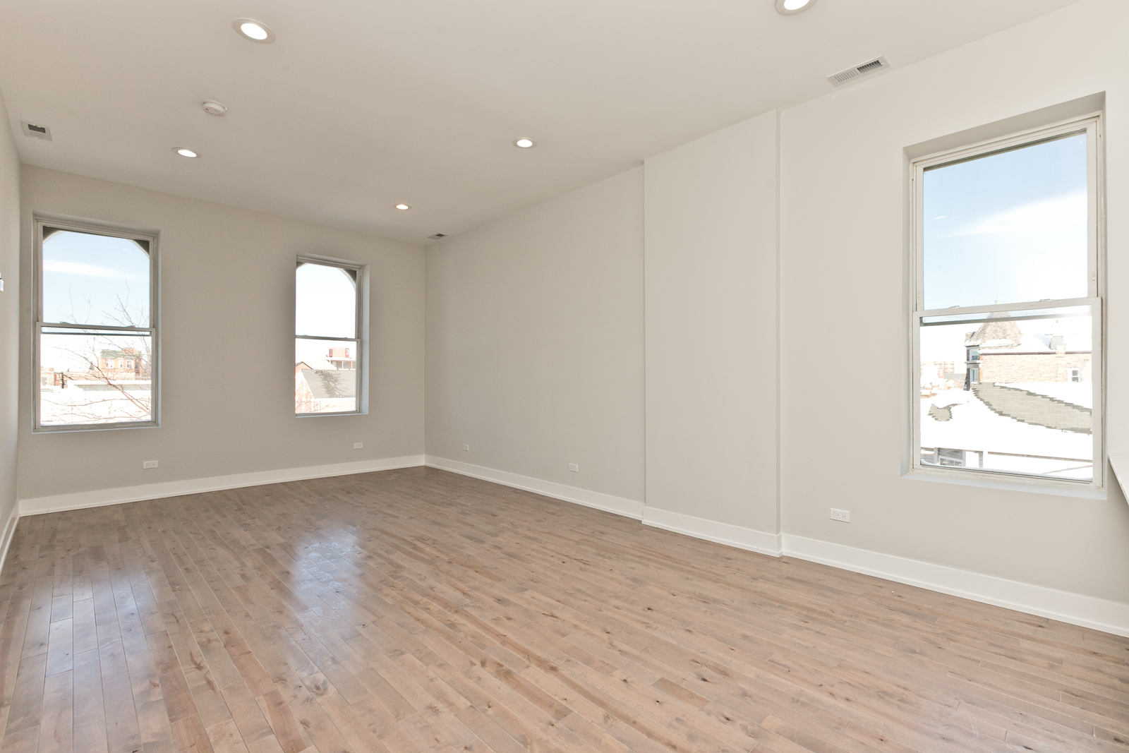 1925 South May Street, Unit 3F Chicago, IL 60608 - Photo 5 of 10 an empty room with wooden floor and windows