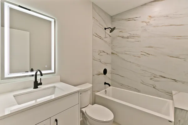 a bathroom with a sink a toilet and a bathtub