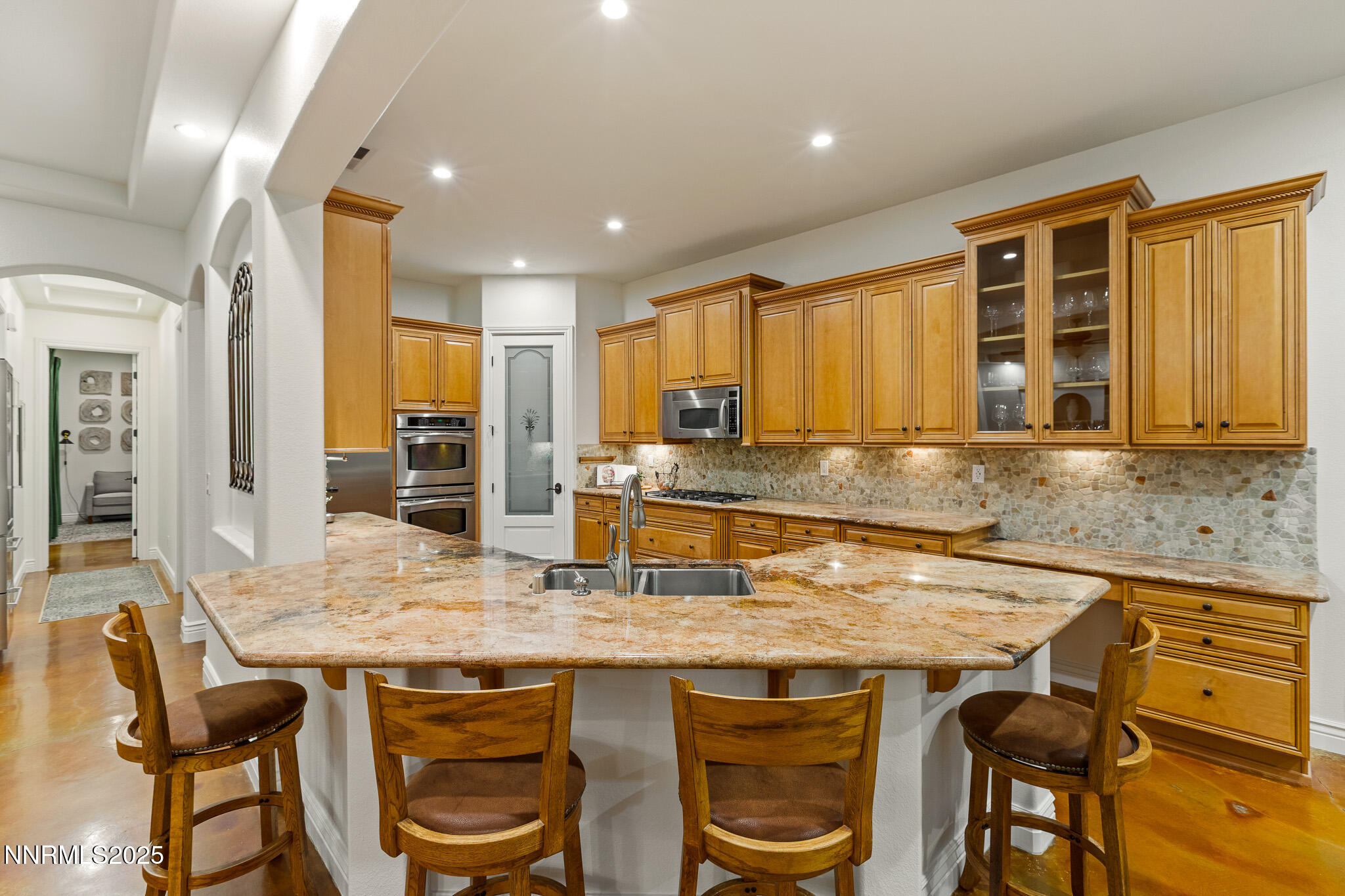 6805 Sage Canyon Road Reno, NV 89510 - Photo 13 of 40 a kitchen with granite countertop kitchen island stainless steel appliances a sink and cabinets