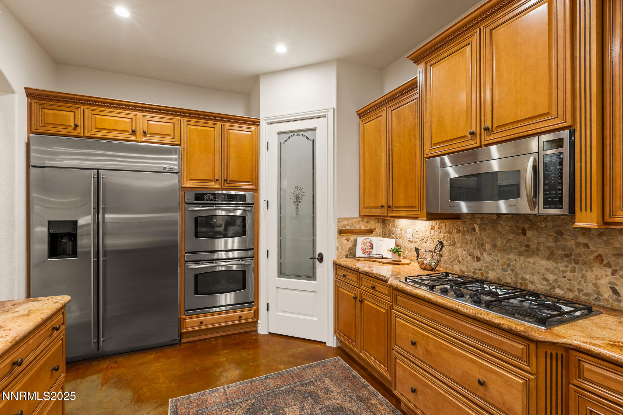 6805 Sage Canyon Road Reno, NV 89510 - Photo 14 of 40 a kitchen with stainless steel appliances granite countertop a refrigerator stove and sink
