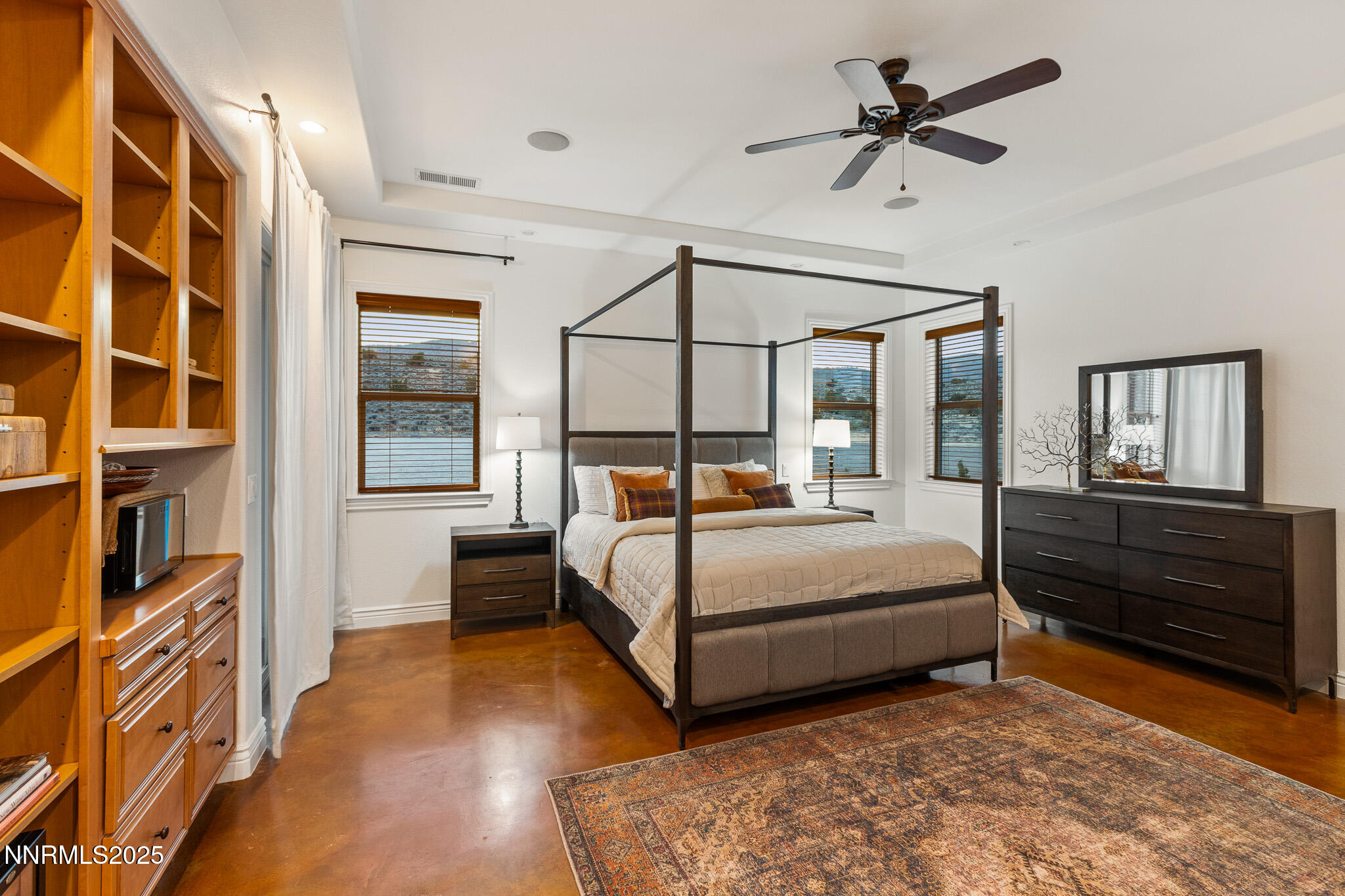 6805 Sage Canyon Road Reno, NV 89510 - Photo 17 of 40 a bedroom with a bed next to a window and a chandelier
