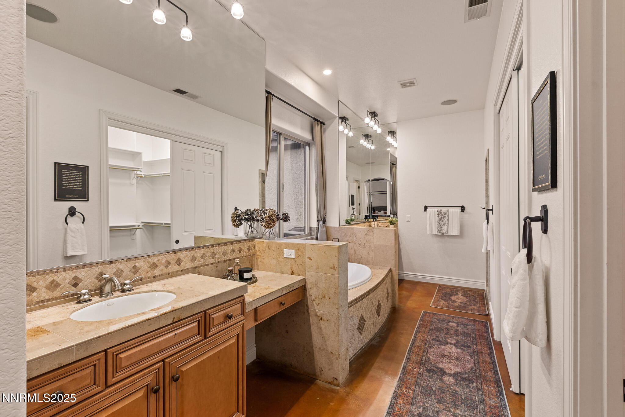 6805 Sage Canyon Road Reno, NV 89510 - Photo 18 of 40 a bathroom with a double vanity sink a mirror and a shower