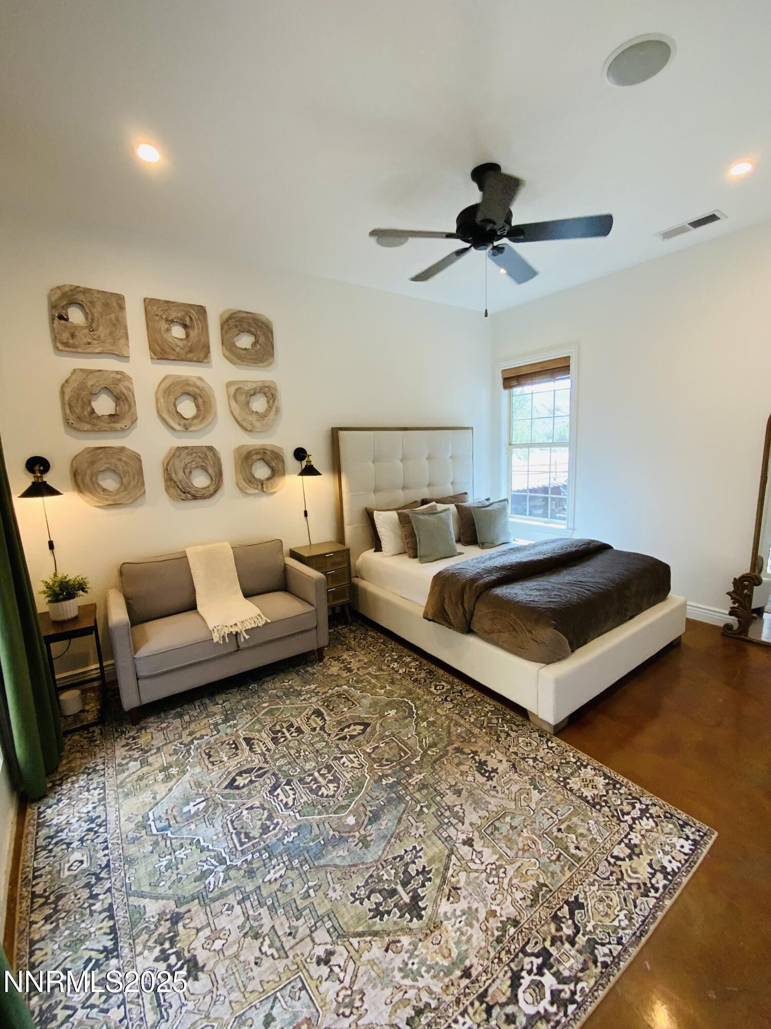 6805 Sage Canyon Road Reno, NV 89510 - Photo 22 of 40 a bedroom with a bed a couch and window