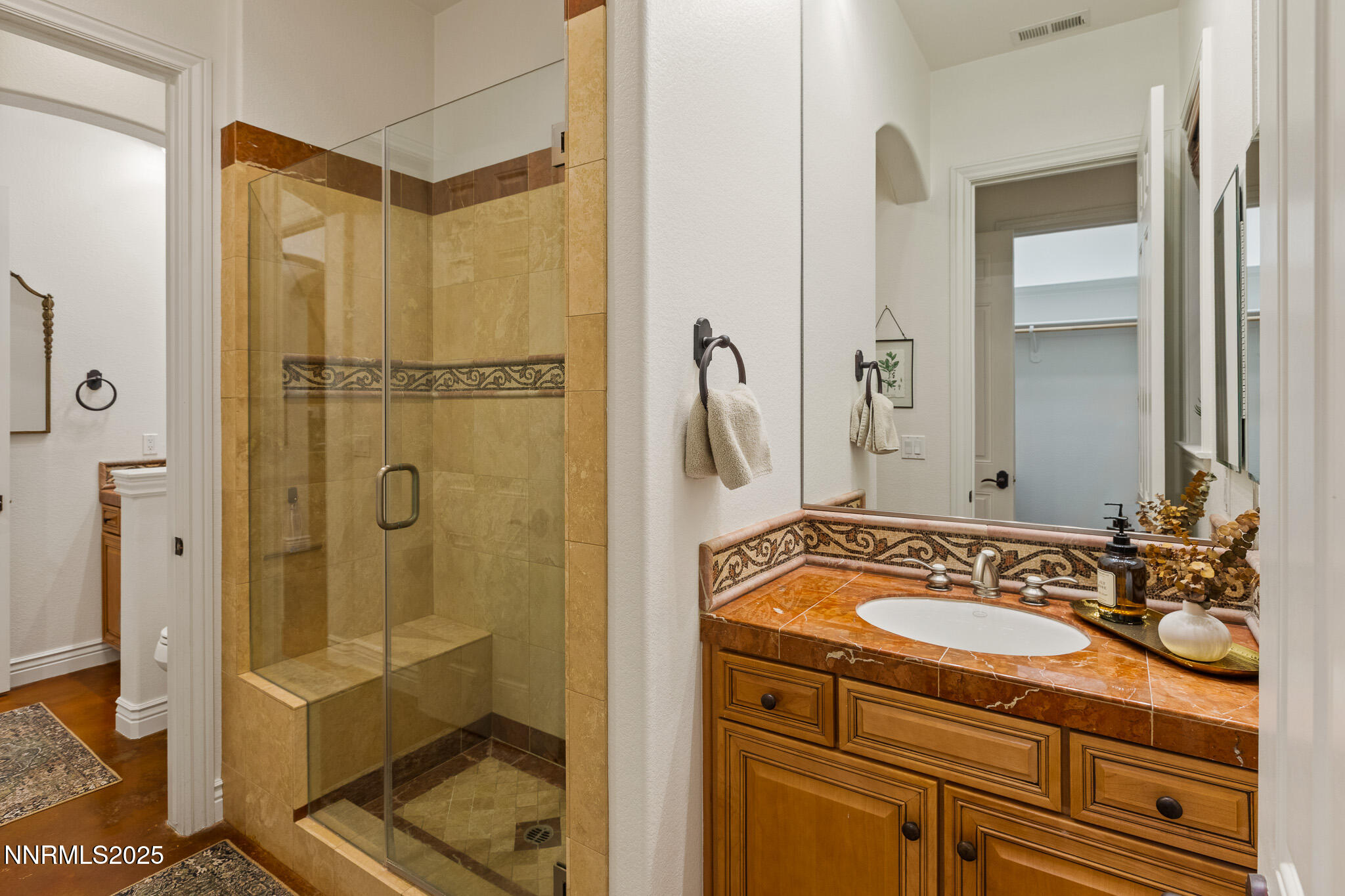 6805 Sage Canyon Road Reno, NV 89510 - Photo 26 of 40 a bathroom with a sink a mirror and a shower