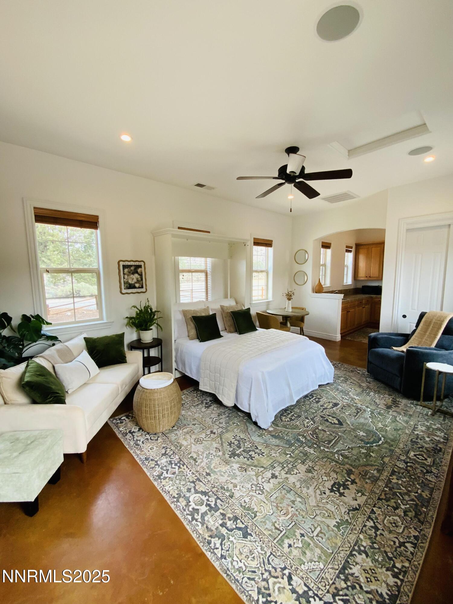6805 Sage Canyon Road Reno, NV 89510 - Photo 29 of 40 a spacious bedroom with a bed a couch and dresser
