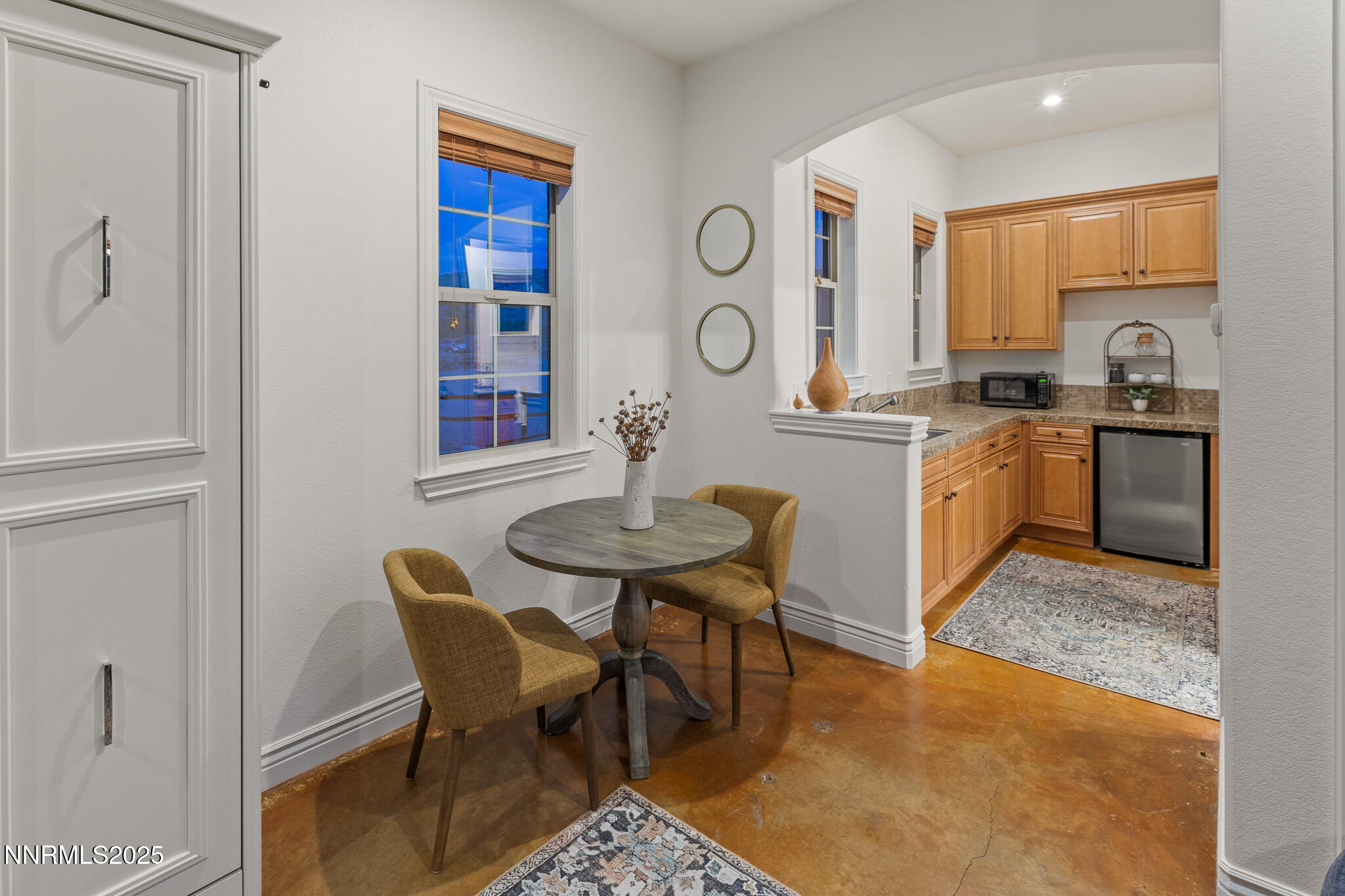 6805 Sage Canyon Road Reno, NV 89510 - Photo 30 of 40 a kitchen with stainless steel appliances granite countertop a stove a sink a dining table and chairs