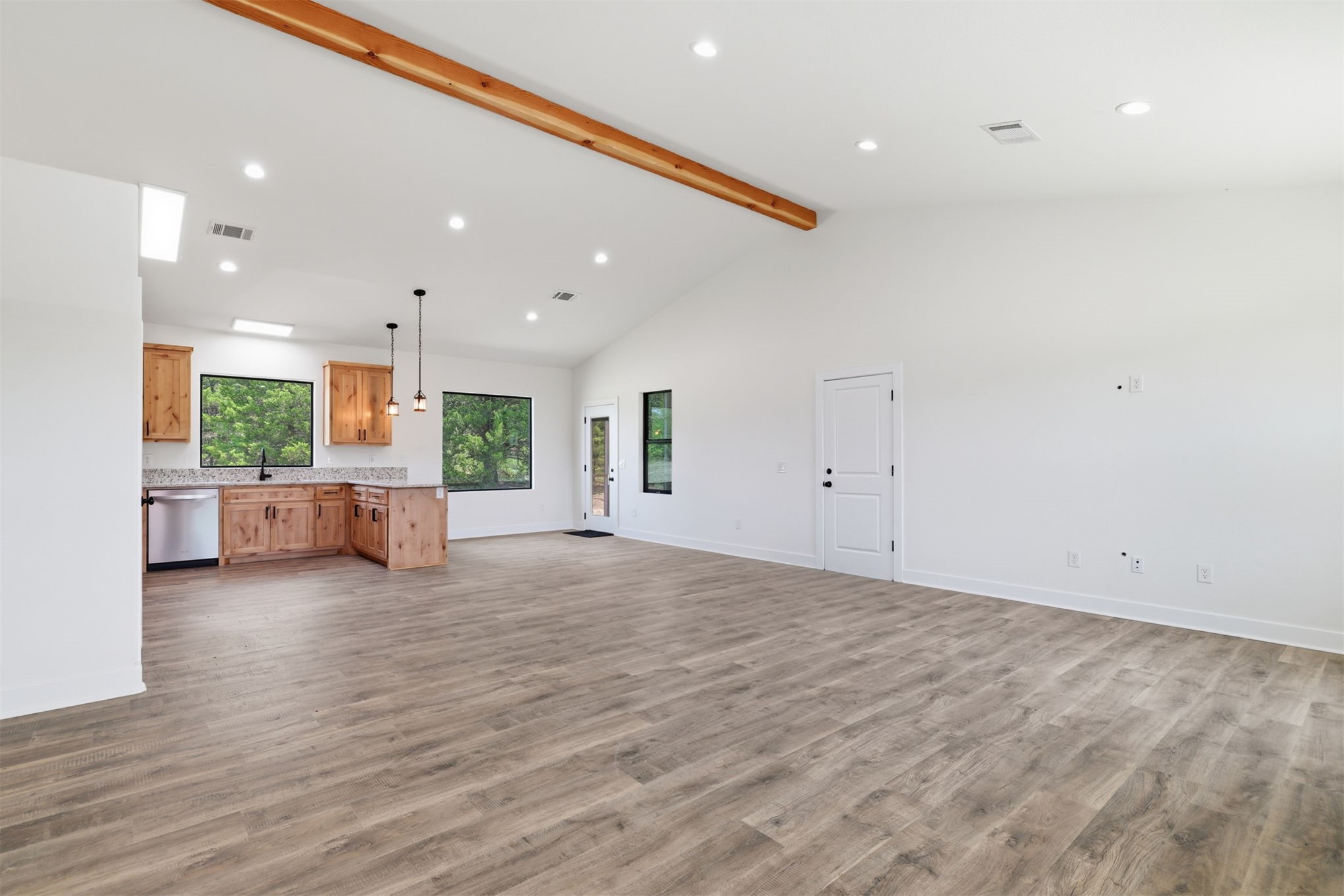63 Deerfield Road Colbert, OK 74733 - Photo 4 of 33 Open-concept living space with vaulted ceilings featuring a prominent exposed wood beam